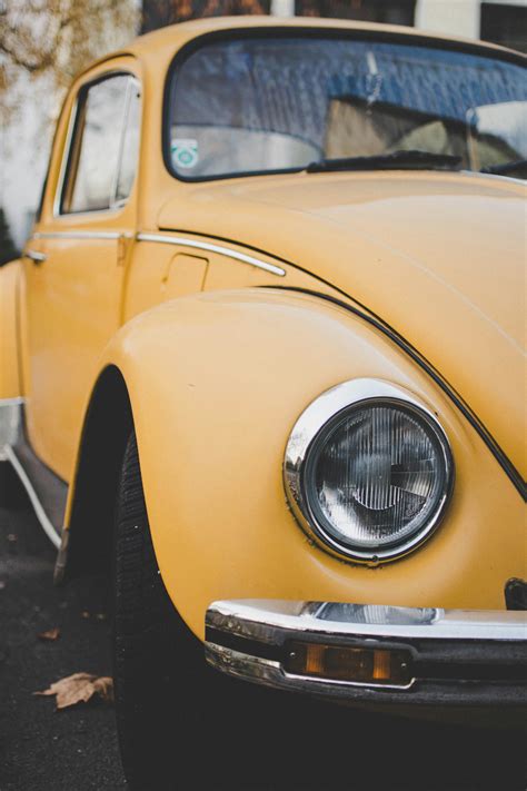 Yellow Volkswagen Beetle Coupe Parked On Gray Concrete Surface · Free