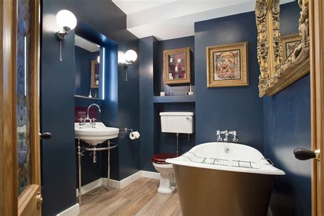 Glamorous Bathroom Boudoir With Rich Blue Walls And Gold