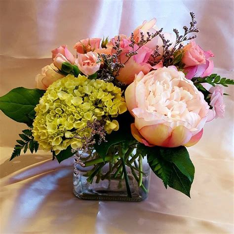 centerpiece cube vase with fresh green mini hydrangeas fresh pink spray roses fresh pink