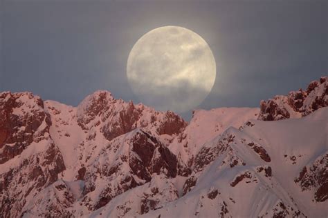 Full Moon Rises Behind Snow Covered Mountains In Hakkari Turkey On