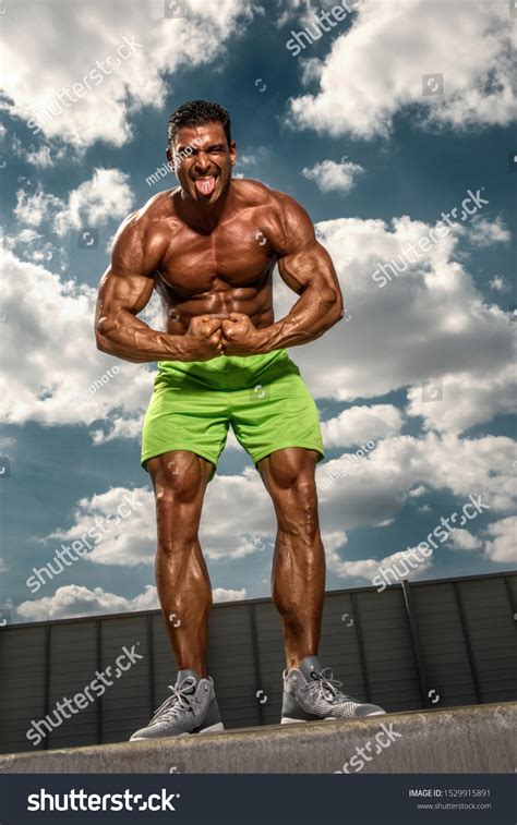 Handsome Muscular Men Flexing Muscles Outdoors Stock Photo 1529915891