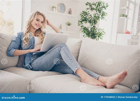 Profile Photo Of Beautiful Charming Barefoot Lady Relaxing Lying Comfy Couch Browsing Notebook