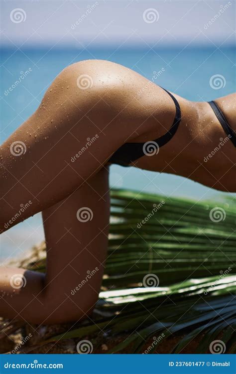 Close Up Female Unrecognizable Tanned Back And Buttocks In Black Bikini