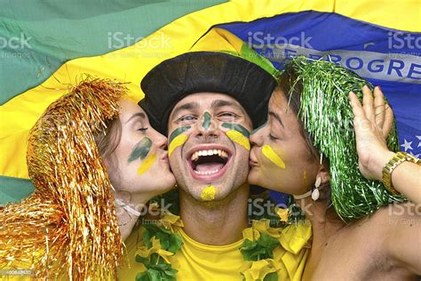 Group Of Brazilian Soccer Fans Celebrating Victory Kissing Each Other