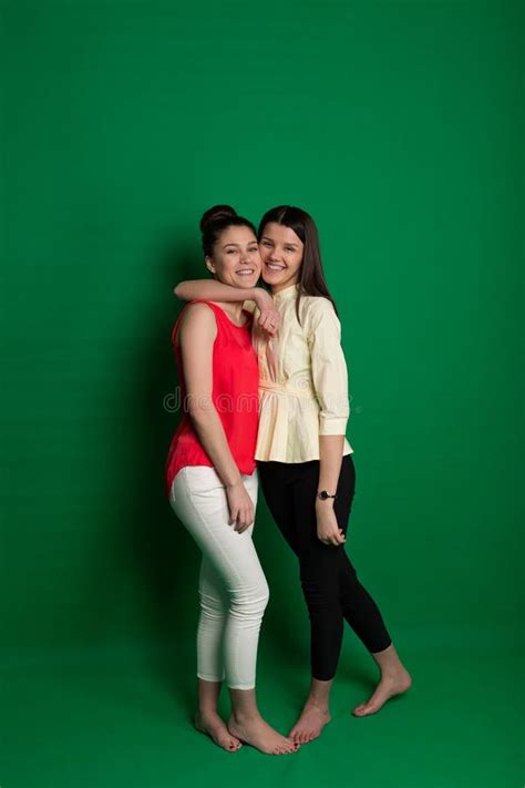 Two Brunette Girlfriends Posing On Green Background Stock Image Image