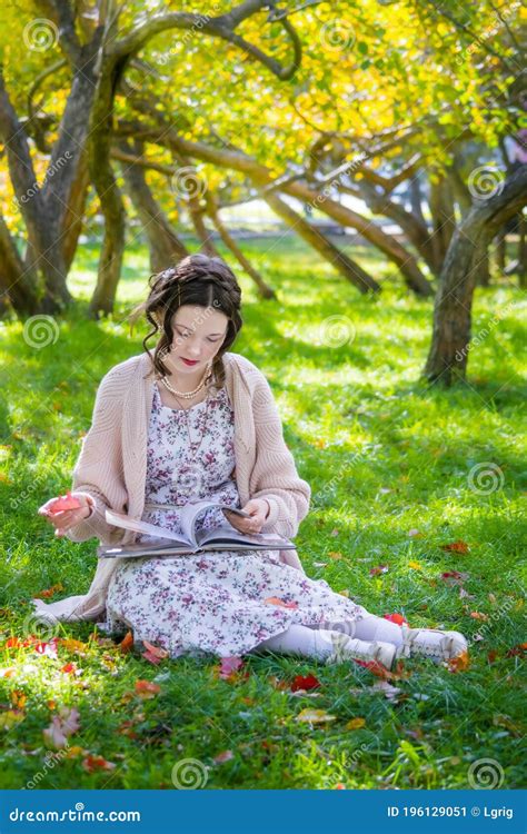 Happy Girl Is Sitting Under A Tree And Reading Book Stock Image Image