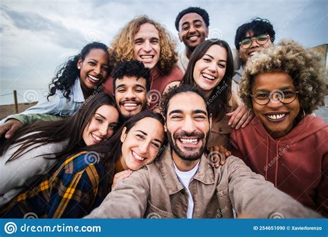 Multiracial Young Group Of Happy People Taking Selfie Together Stock