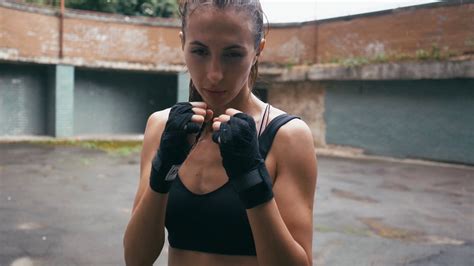 Beautiful Mixed Race Kickboxing Woman Training Under Rain Outdoors Fierce Strength Fit Body