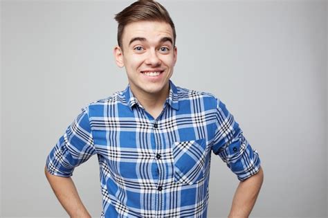 Premium Photo Happy Guy Dressed In A Plaid Shirt Smiles On A White