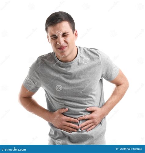 Young Man Suffering From Abdominal Pain On White Background Stock Photo