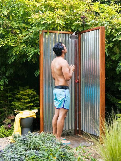 A Man Standing In Front Of A Metal Shower