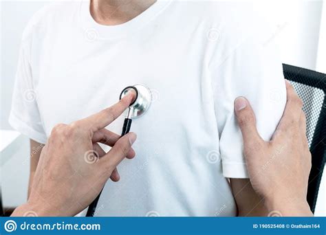 Male Doctors Perform A Pulse Examination Using A Stethoscope Initial