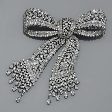A Diamond Brooch Of Openworked Tied Ribbon Bow Design Decorated With