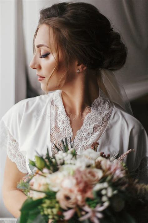 Gorgeous Beautiful Bride In Silk Robe And Veil Holding Modern Bo Stock