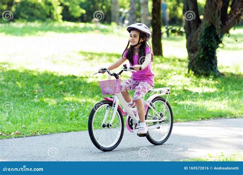Little Girl Riding Her Bicycle In A Park Stock Photo Image Of Little