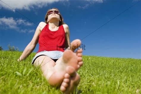 Young Woman Sitting Barefoot In Summer Meadow Relaxing Download P