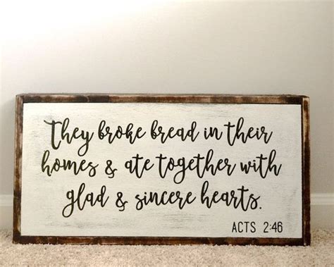 A Wooden Sign That Says They Broke Bread In Their Homes And Ate