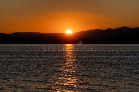 Colorful Water Surface During Sunrise Big Sun And Silhouette Of