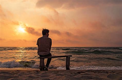 Best Man Sitting Alone Looking At The Beach Stock Photos Pictures