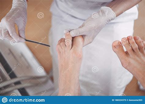 Pedicurist Doing Professional Medical Pedicure Procedure In Beauty