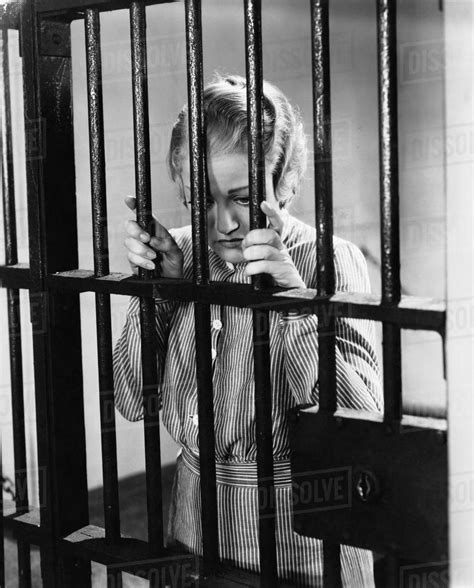 Young Woman Standing In A Prison Cell Stock Photo Dissolve