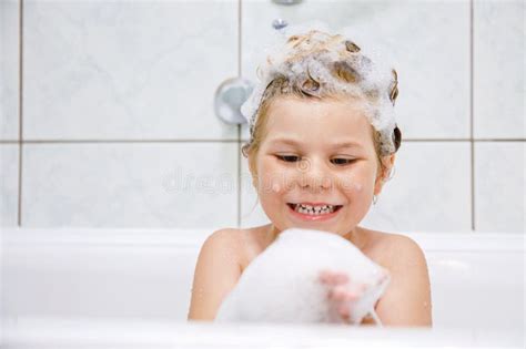 Child In The Bath With Bubbles Happy Child Enjoying Bath Time Little