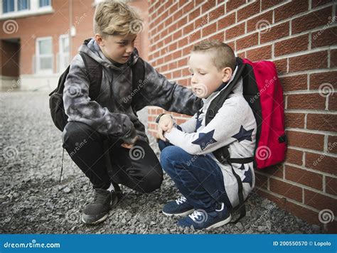 Boy Problem At School Sitting And Consoling Child Each Other Stock