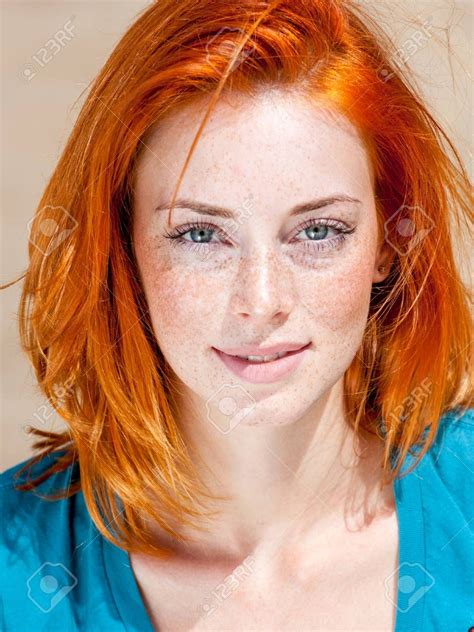 Outdoor Portrait Of A Beautiful Redhead Freckled Blue Eyed Woman