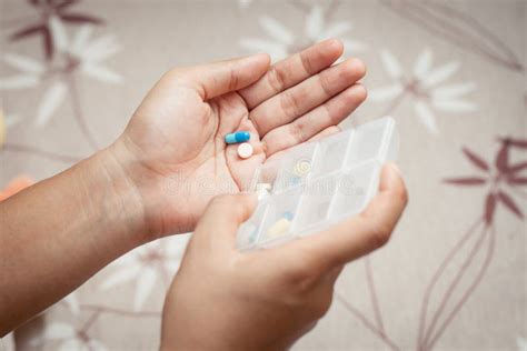 Woman Hand Pouring Pills From A Pill Reminder Box Stock Photo Image