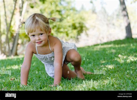 Little Girl Playing On Grass Stock Photo Alamy