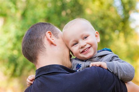 Happy Father And His Son Outdoors Child Hugging Daddy Stock Photo