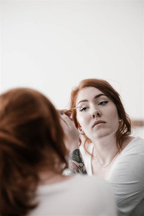 Redhead Girl Applying Mascara In The Mirror Douglas J