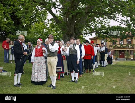 People In Traditional Swedish Folk Costumes At Midsummer Celebration