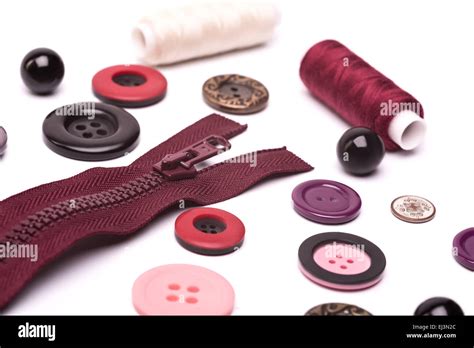Maroon Zipper Coil Colored Threads And Buttons In Different Shapes And