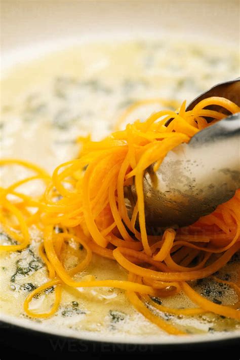 Cooking Butternut Squash Noodles In Sage Butter Stock Photo