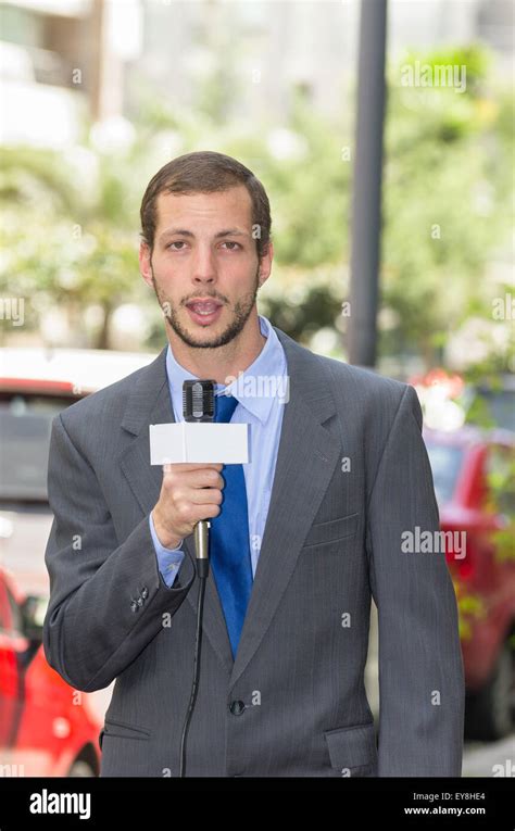 Attractive Professional Male News Reporter Wearing Grey Suit Holding