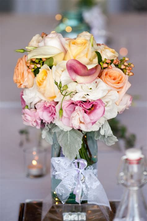 Mason Jar Centerpieces With Peach Pink And White Flowers