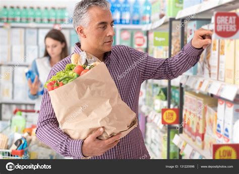 Man Shopping At Supermarket — Stock Photo © Stokkete 131220996