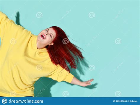Happy Plump Female With Flowing Red Hair Dancing Or Jumping With Her