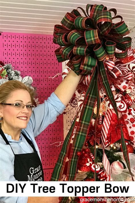 A Woman Holding Up A Large Bow In Front Of A Christmas Tree With Candy
