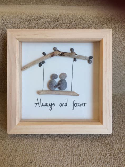 Pebble art - couple on a swing | Pebble art, Pebble art family, Rock crafts
