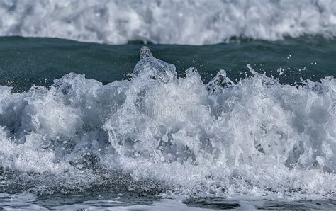 Water Splashes On Seaocean Wave Crest Against Blurred Bac Stock Photo