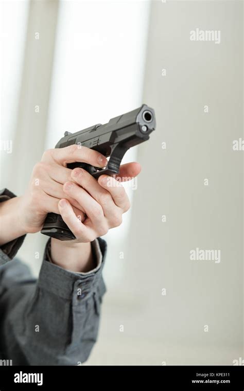 A Hand Holding Gun And Pointing It At Camera Hi Res Stock Photography