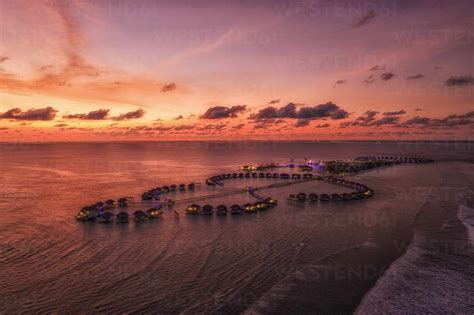 aerial view of a beautiful luxury resort at sunset on alifu dhaalu atoll in north central