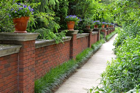 Beautiful Brick Fence With Potted Plants On Top And Awesome Landscaping