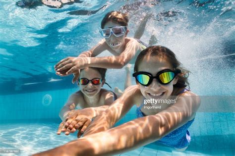Happy Kids Swimming Underwater In Pool High Res Stock Photo Getty Images