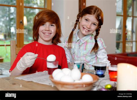 Boy And Girl Coloring Easter Eggs Painting Easter Eggs Stock Photo Alamy