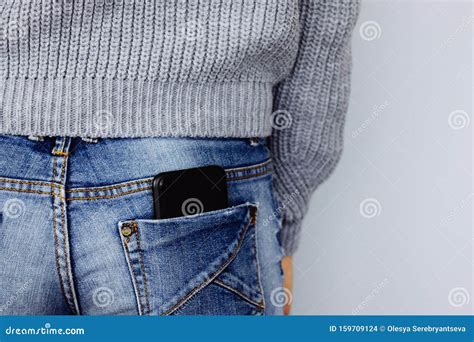 A Mobile Phone In The Back Pocket Of A Jeans On A Girl In Casual