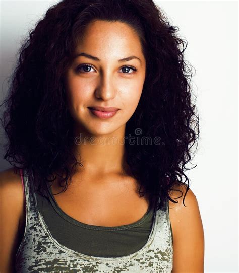 Young Pretty Girl With Curly Hair Posing Cheerful On White Background