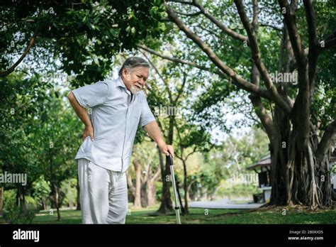 Old Man With Cane Suffering From Back Pain Stock Photo Alamy